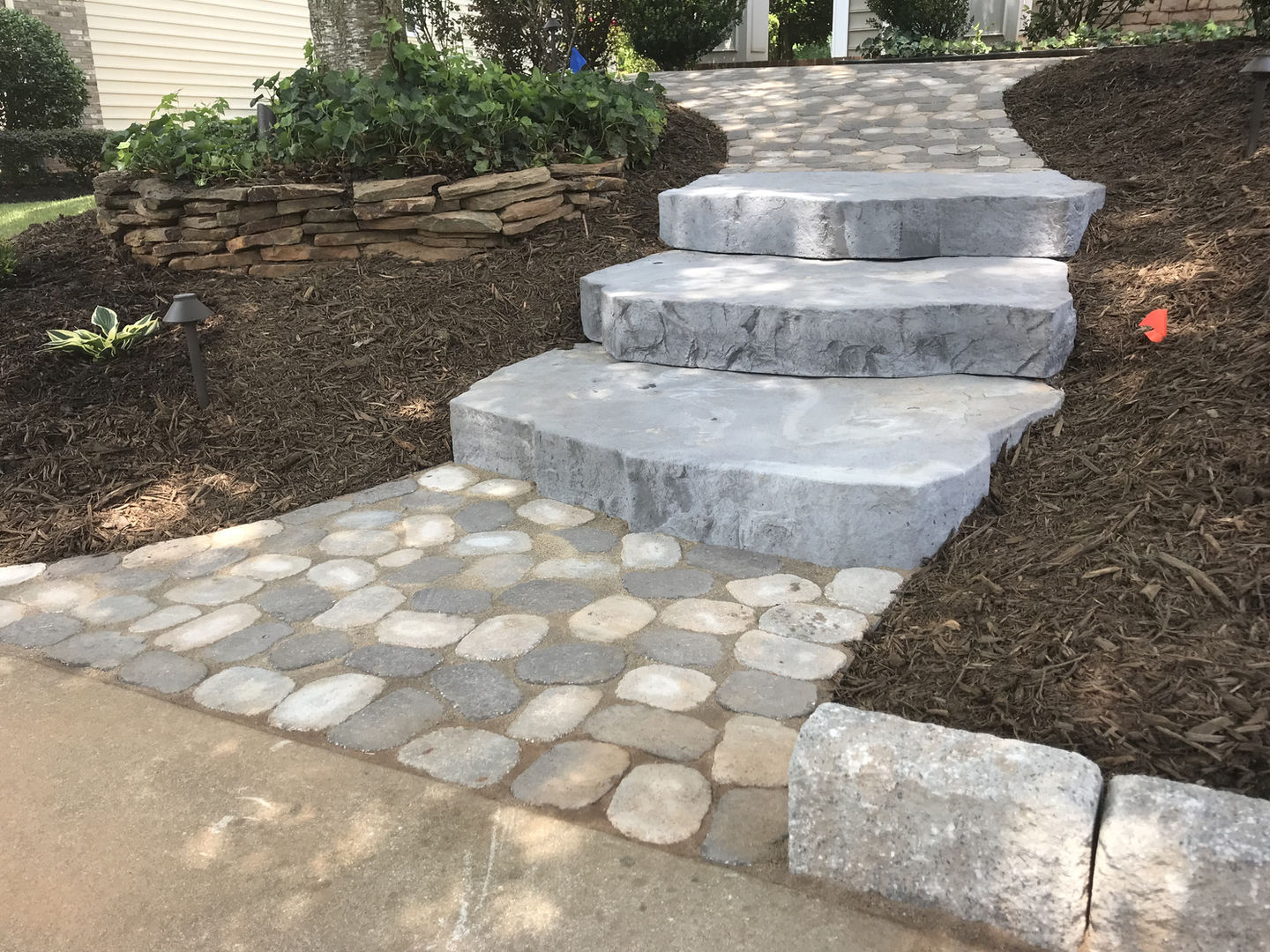 Large stone block stairway to heaven leading up a garden.
